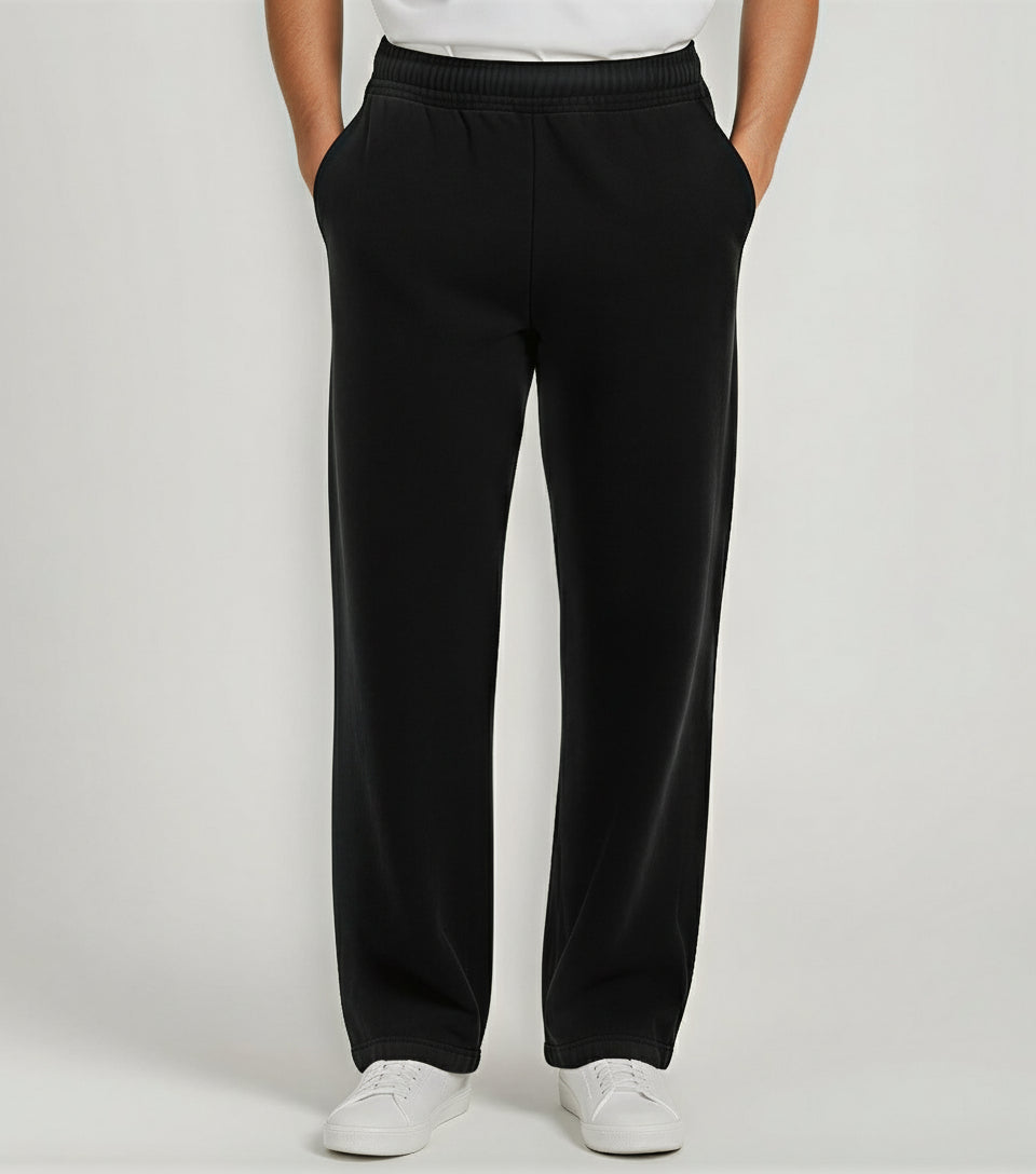 Person wearing black pants on a white background